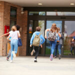 children running into school