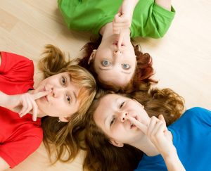 three women with fingers to their lips