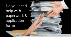 piles of paperwork with a hand seek help appearing from beneath the reams