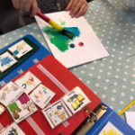 Pecs communication book and a child painting
