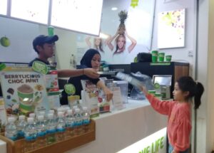 A girl uses pictures to order food at a food counter